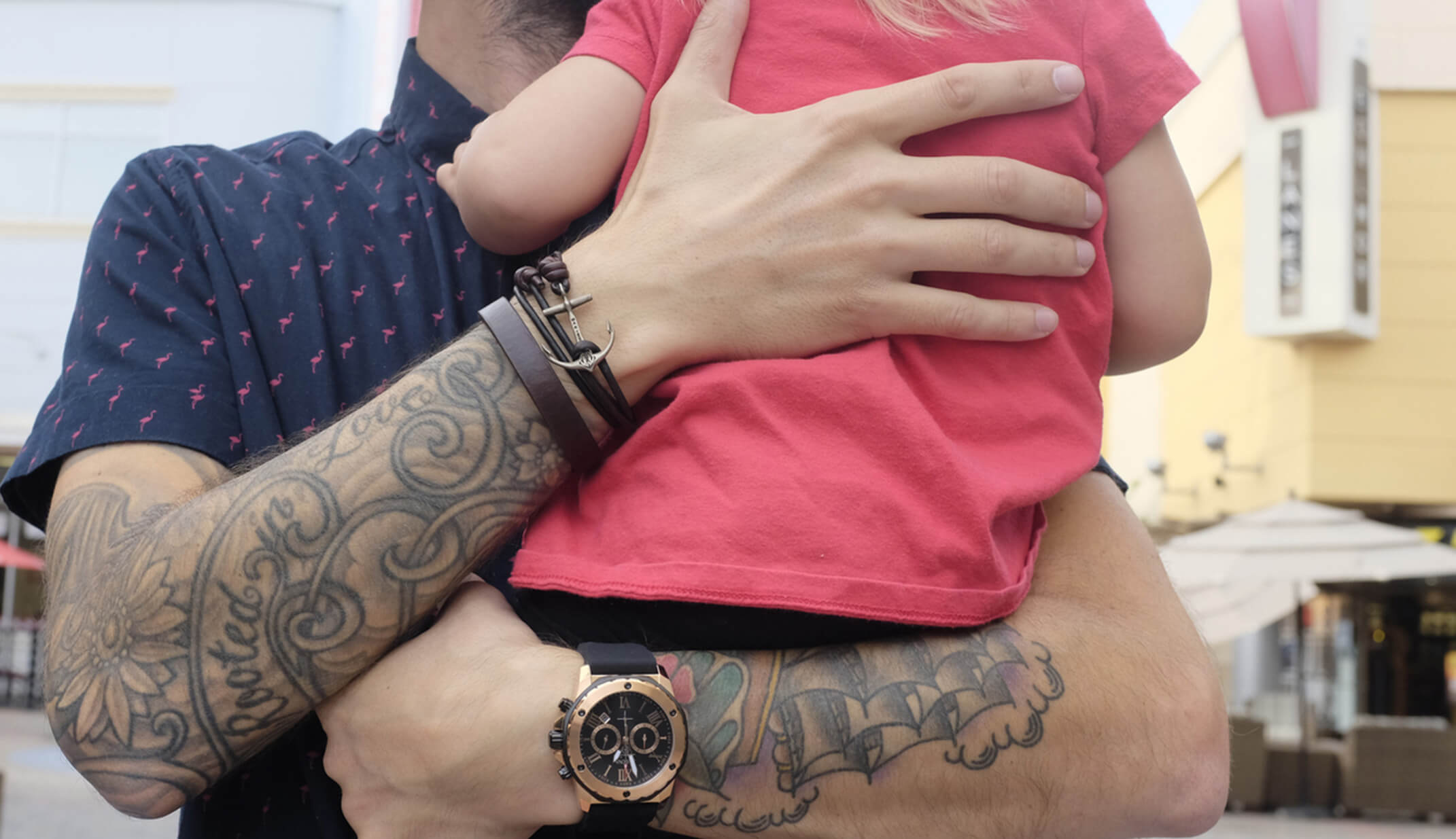 hipster father holding daughter watch hand tattoos shirt town portrait street men family love hug hands freelance bulova UGC content